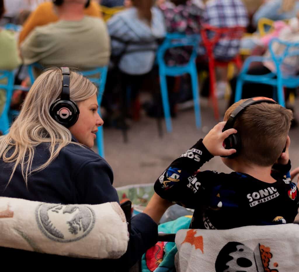 Audience enjoying a film at Sunrise Film Festival outdoor event.