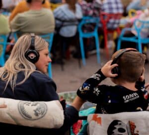 Audience enjoying a film at Sunrise Film Festival outdoor event.